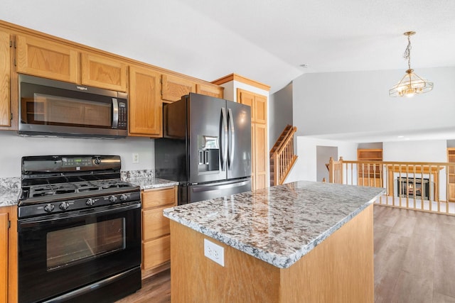 10779 57th St NE, Albertville, MN 55301 - kitchen with gas stove, fridge with ice dispenser, light wood finished floors, a center island, and vaulted ceiling