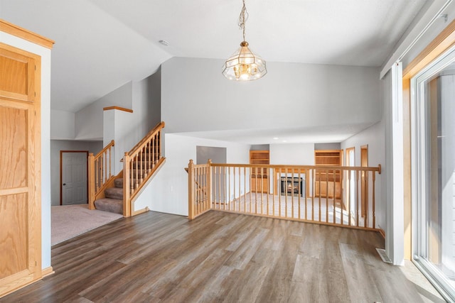 10779 57th St NE, Albertville, MN 55301 - spare room with wood finished floors, high vaulted ceiling, and a chandelier