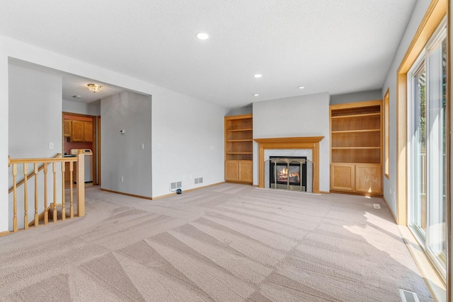 10779 57th St NE, Albertville, MN 55301 - unfurnished living room with light carpet, washer / clothes dryer, recessed lighting, and a fireplace