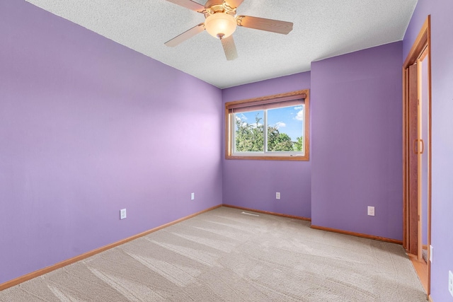 10779 57th St NE, Albertville, MN 55301 - unfurnished bedroom with a textured ceiling, light colored carpet, and ceiling fan