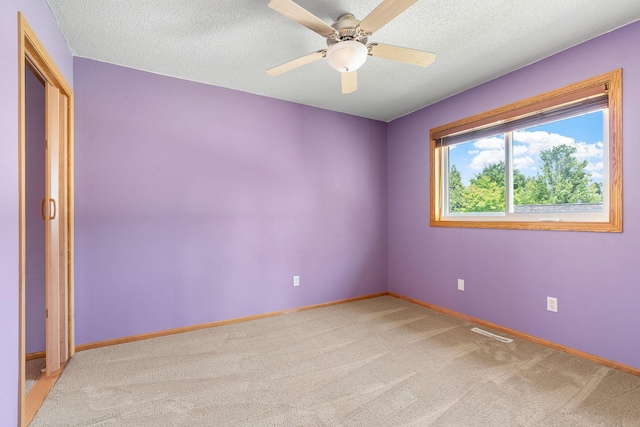 10779 57th St NE, Albertville, MN 55301 - unfurnished room featuring a textured ceiling, light carpet, and a ceiling fan