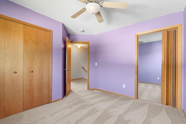 10779 57th St NE, Albertville, MN 55301 - unfurnished bedroom featuring a closet, light colored carpet, and ceiling fan