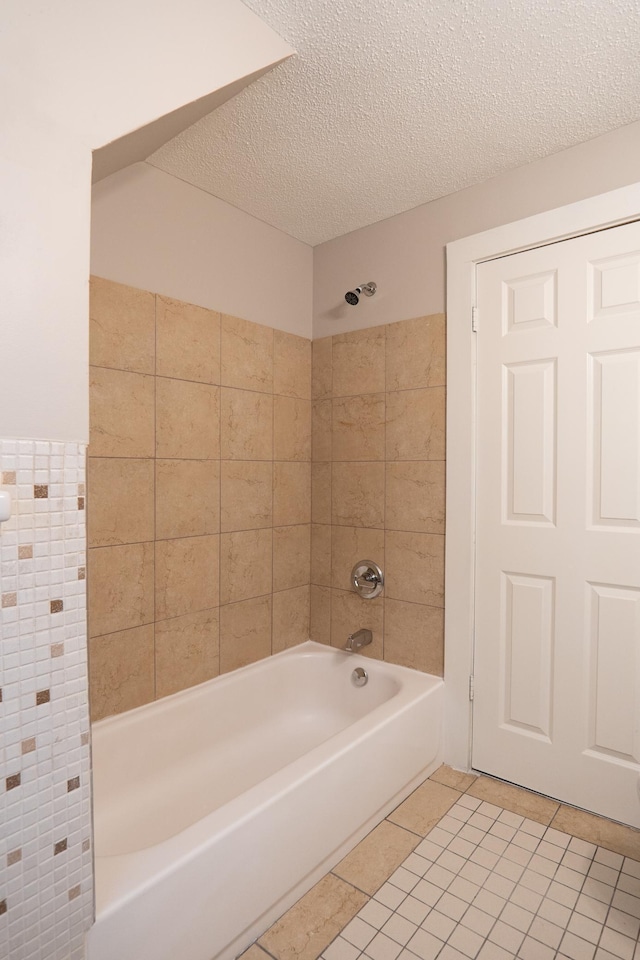 922 Minnehaha Ave E, Saint Paul, MN 55106 - bathroom featuring tile patterned flooring, shower / tub combination, a textured ceiling, and tile walls