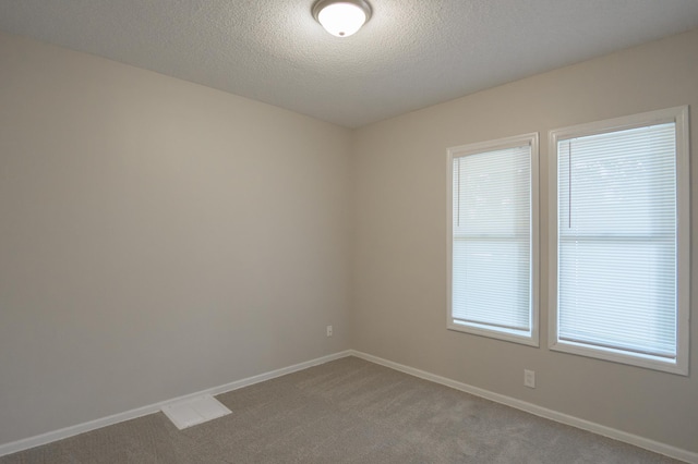 922 Minnehaha Ave E, Saint Paul, MN 55106 - carpeted empty room with baseboards and a textured ceiling
