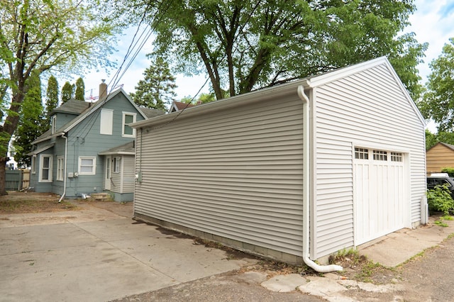 922 Minnehaha Ave E, Saint Paul, MN 55106 - view of property exterior featuring a garage, a patio, and an outbuilding