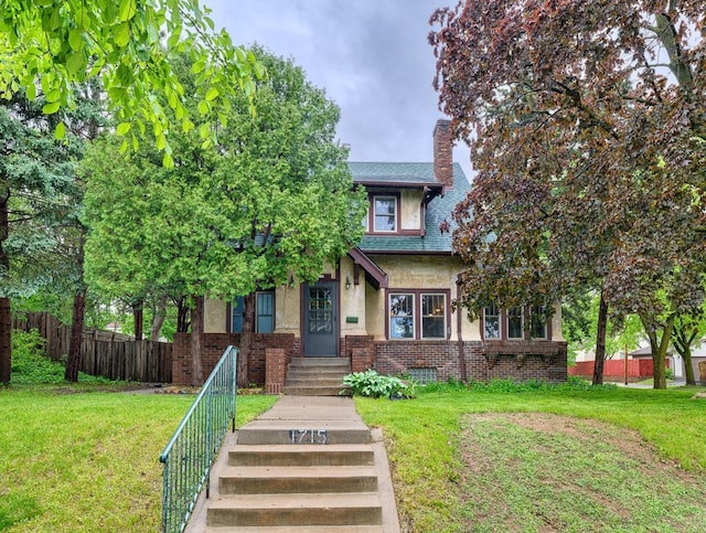 1715 Bush Ave, Saint Paul, MN 55106 - view of front of property featuring a chimney, stucco siding, and brick siding