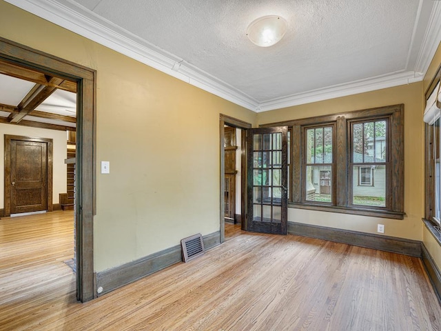 1715 Bush Ave, Saint Paul, MN 55106 - empty room with wood finished floors, ornamental molding, baseboards, and a textured ceiling