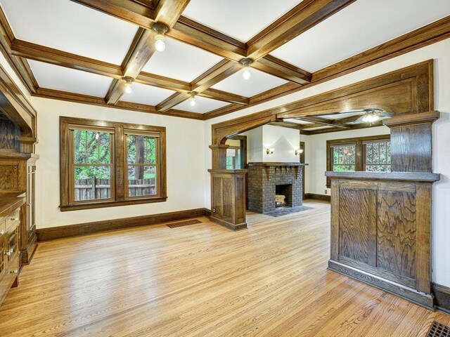1715 Bush Ave, Saint Paul, MN 55106 - unfurnished living room featuring light wood-style floors, healthy amount of natural light, baseboards, beam ceiling, and coffered ceiling