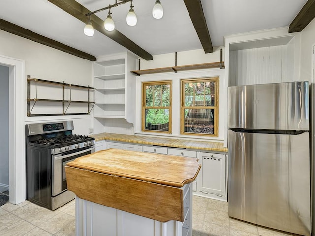1715 Bush Ave, Saint Paul, MN 55106 - kitchen featuring appliances with stainless steel finishes, beam ceiling, wood counters, a center island, and white cabinets