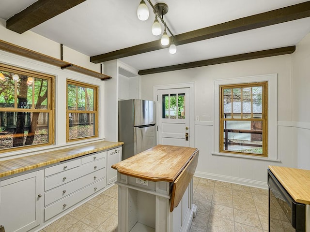 1715 Bush Ave, Saint Paul, MN 55106 - kitchen featuring wooden counters, freestanding refrigerator, beamed ceiling, and white cabinetry
