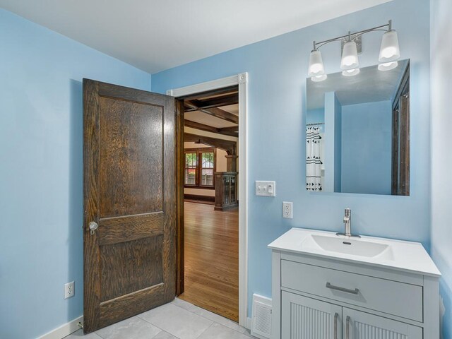 1715 Bush Ave, Saint Paul, MN 55106 - bathroom with vanity, baseboards, and tile patterned floors