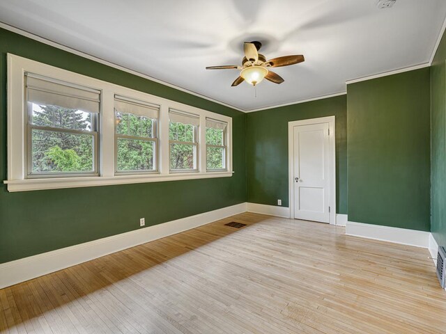 1715 Bush Ave, Saint Paul, MN 55106 - spare room with baseboards, ceiling fan, light wood-type flooring, and ornamental molding