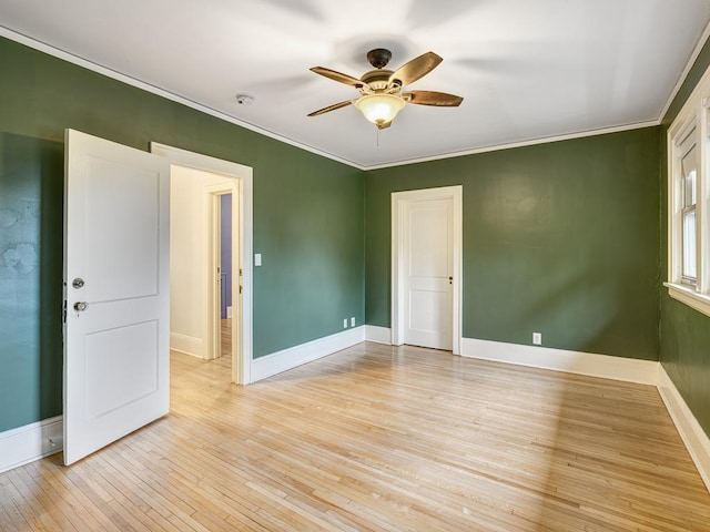 1715 Bush Ave, Saint Paul, MN 55106 - empty room featuring ceiling fan, light wood-style floors, ornamental molding, and baseboards
