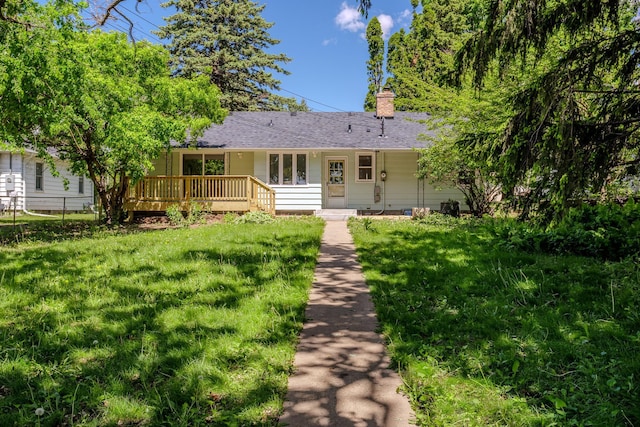 2512 27th Ave NE, Saint Anthony, MN 55418 - view of front facade featuring a wooden deck, a chimney, and roof with shingles