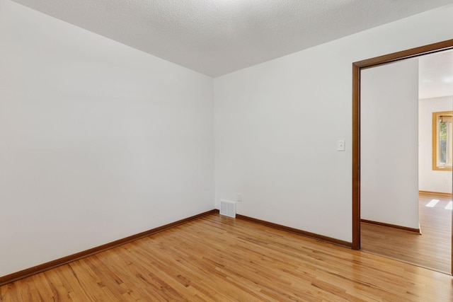 11124 Welcome Ave N, Champlin, MN 55316 - unfurnished room with light wood-type flooring and baseboards