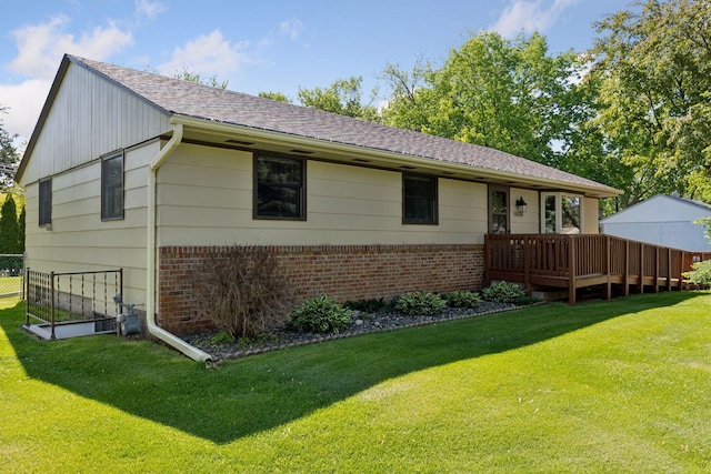 11124 Welcome Ave N, Champlin, MN 55316 - view of front facade with brick siding, a front lawn, roof with shingles, and a deck