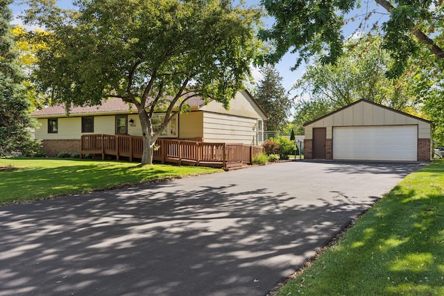 11124 Welcome Ave N, Champlin, MN 55316 - view of front facade with a detached garage, an outdoor structure, a front yard, and brick siding