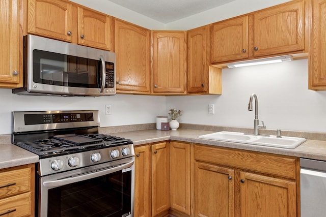 11124 Welcome Ave N, Champlin, MN 55316 - kitchen with stainless steel appliances, a sink, and light countertops