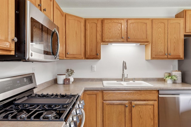 11124 Welcome Ave N, Champlin, MN 55316 - kitchen with appliances with stainless steel finishes, a sink, and light countertops