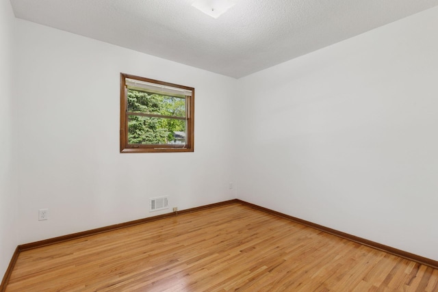 11124 Welcome Ave N, Champlin, MN 55316 - unfurnished room featuring light wood-type flooring and baseboards