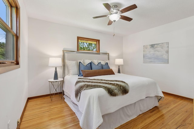 11124 Welcome Ave N, Champlin, MN 55316 - bedroom with baseboards, light wood-style floors, and a ceiling fan
