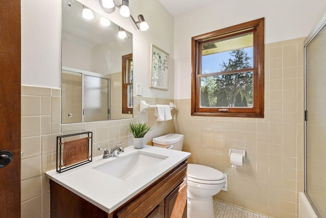 11124 Welcome Ave N, Champlin, MN 55316 - full bath with tile walls, toilet, vanity, tile patterned floors, and wainscoting