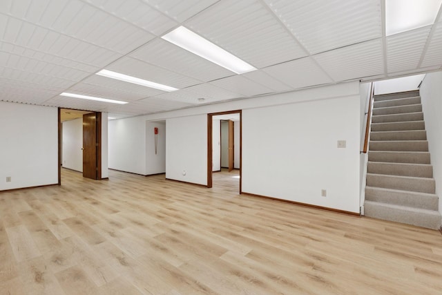 11124 Welcome Ave N, Champlin, MN 55316 - unfurnished room with stairway, light wood-type flooring, and baseboards