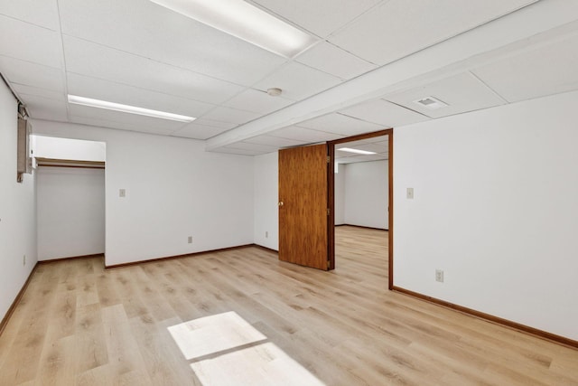 11124 Welcome Ave N, Champlin, MN 55316 - unfurnished bedroom with light wood finished floors, baseboards, a drop ceiling, and a closet