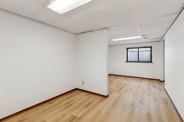 11124 Welcome Ave N, Champlin, MN 55316 - empty room with light wood-style floors, a drop ceiling, and baseboards