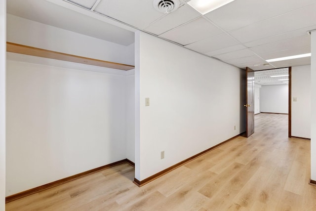 11124 Welcome Ave N, Champlin, MN 55316 - interior space featuring light wood-style flooring, baseboards, and a paneled ceiling