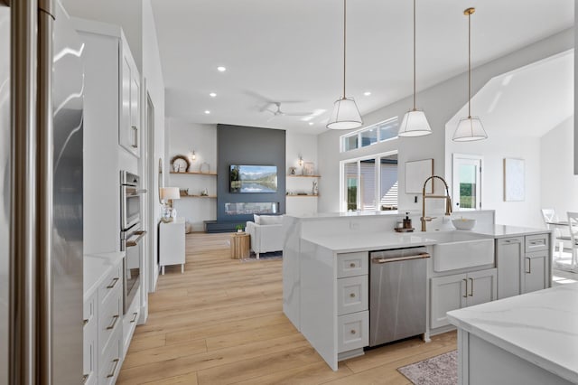 2520 230th Ct NW, Saint Francis, MN 55070 - kitchen with stainless steel appliances, a sink, recessed lighting, light wood-type flooring, and open floor plan