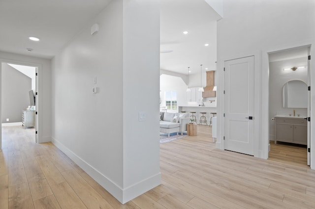 2520 230th Ct NW, Saint Francis, MN 55070 - hall featuring light wood-style flooring, a sink, baseboards, and recessed lighting