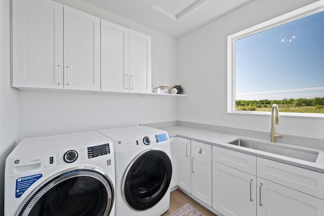 2520 230th Ct NW, Saint Francis, MN 55070 - washroom featuring cabinet space, independent washer and dryer, and light wood-style flooring