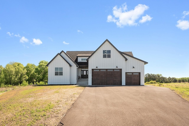 2520 230th Ct NW, Saint Francis, MN 55070 - modern farmhouse featuring board and batten siding, driveway, and a front lawn
