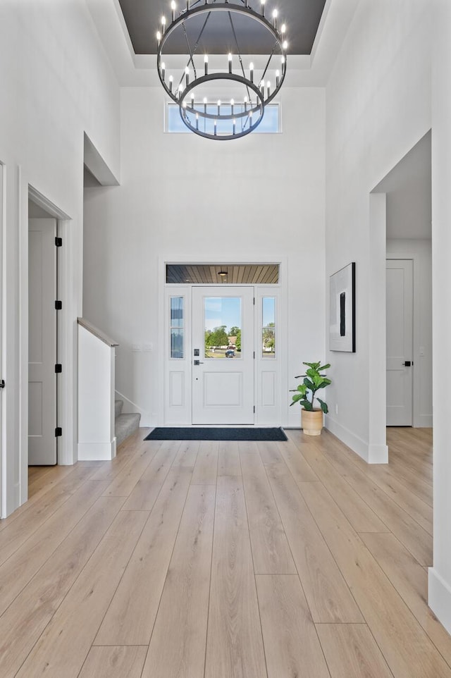 2520 230th Ct NW, Saint Francis, MN 55070 - entrance foyer featuring a towering ceiling, a chandelier, stairway, baseboards, and wood finished floors