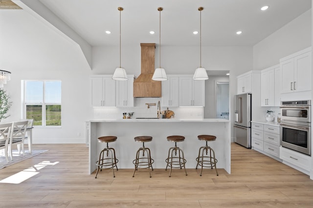 2520 230th Ct NW, Saint Francis, MN 55070 - kitchen featuring high vaulted ceiling, stainless steel appliances, backsplash, light countertops, and a breakfast bar