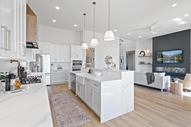 2520 230th Ct NW, Saint Francis, MN 55070 - kitchen featuring stainless steel appliances, open floor plan, a sink, ceiling fan, and tasteful backsplash