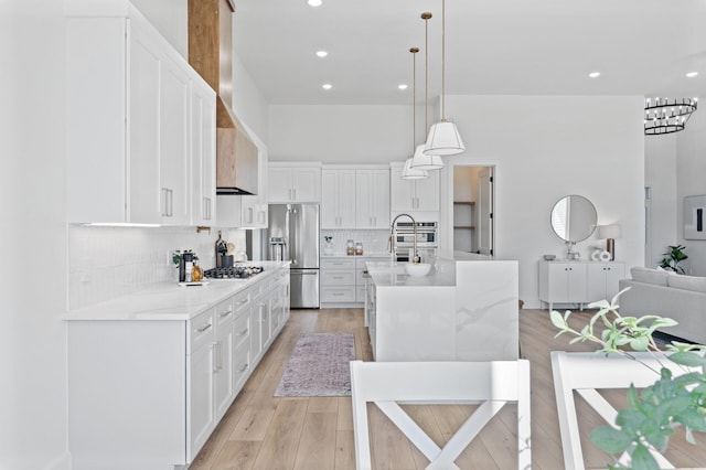 2520 230th Ct NW, Saint Francis, MN 55070 - kitchen with appliances with stainless steel finishes, tasteful backsplash, white cabinets, an island with sink, and recessed lighting