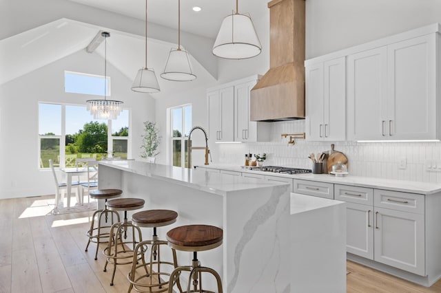 2520 230th Ct NW, Saint Francis, MN 55070 - kitchen featuring high vaulted ceiling, a center island with sink, light stone counters, decorative backsplash, and beamed ceiling