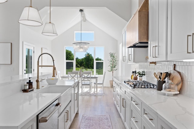 2520 230th Ct NW, Saint Francis, MN 55070 - kitchen featuring stainless steel appliances, a sink, light wood finished floors, custom exhaust hood, and a chandelier
