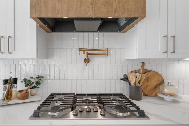 2520 230th Ct NW, Saint Francis, MN 55070 - kitchen view of stainless steel gas stovetop, decorative backsplash, white cabinets, and pot filler