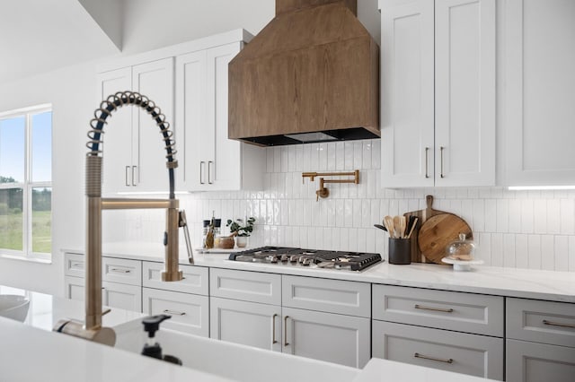2520 230th Ct NW, Saint Francis, MN 55070 - kitchen featuring custom range hood, stainless steel gas stovetop, decorative backsplash, and white cabinets