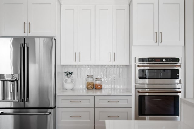 2520 230th Ct NW, Saint Francis, MN 55070 - kitchen featuring appliances with stainless steel finishes, backsplash, white cabinets, and light stone countertops