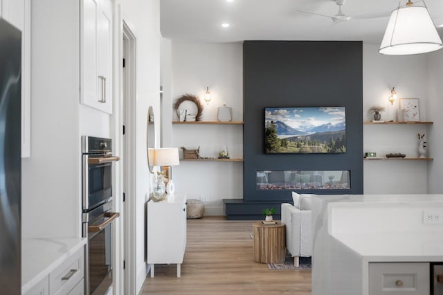 2520 230th Ct NW, Saint Francis, MN 55070 - interior space with open shelves, light wood-style floors, black fridge, stainless steel double oven, and recessed lighting