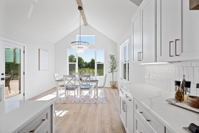 2520 230th Ct NW, Saint Francis, MN 55070 - kitchen with beamed ceiling, light wood-style floors, a chandelier, decorative light fixtures, and tasteful backsplash