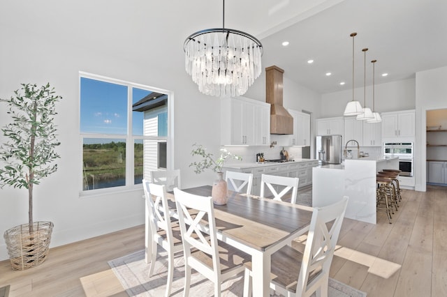 2520 230th Ct NW, Saint Francis, MN 55070 - dining space featuring a high ceiling, light wood finished floors, recessed lighting, a chandelier, and a water view