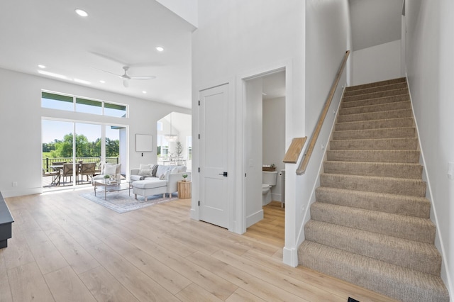 2520 230th Ct NW, Saint Francis, MN 55070 - stairs with a ceiling fan, wood finished floors, recessed lighting, a towering ceiling, and baseboards