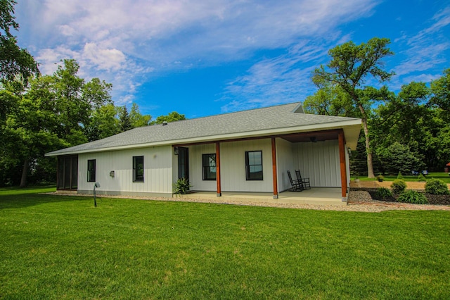 850 60th Ave SW, Benson, MN 56231 - back of property with a yard, a shingled roof, a patio area, and a ceiling fan
