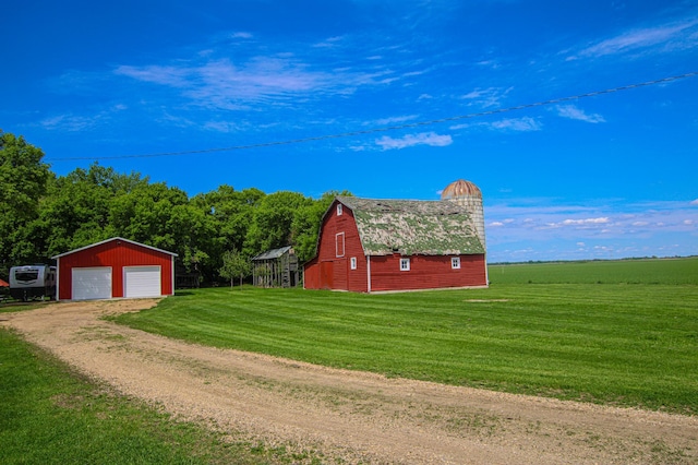 850 60th Ave SW, Benson, MN 56231 - view of side of property with a barn, dirt driveway, an outdoor structure, a gambrel roof, and a yard