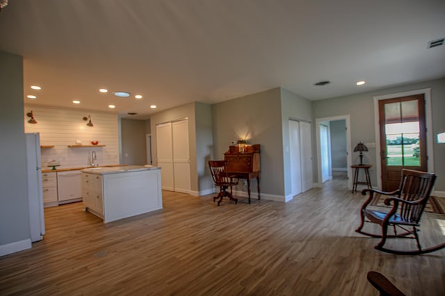850 60th Ave SW, Benson, MN 56231 - kitchen featuring white cabinets, wood finished floors, recessed lighting, white appliances, and baseboards